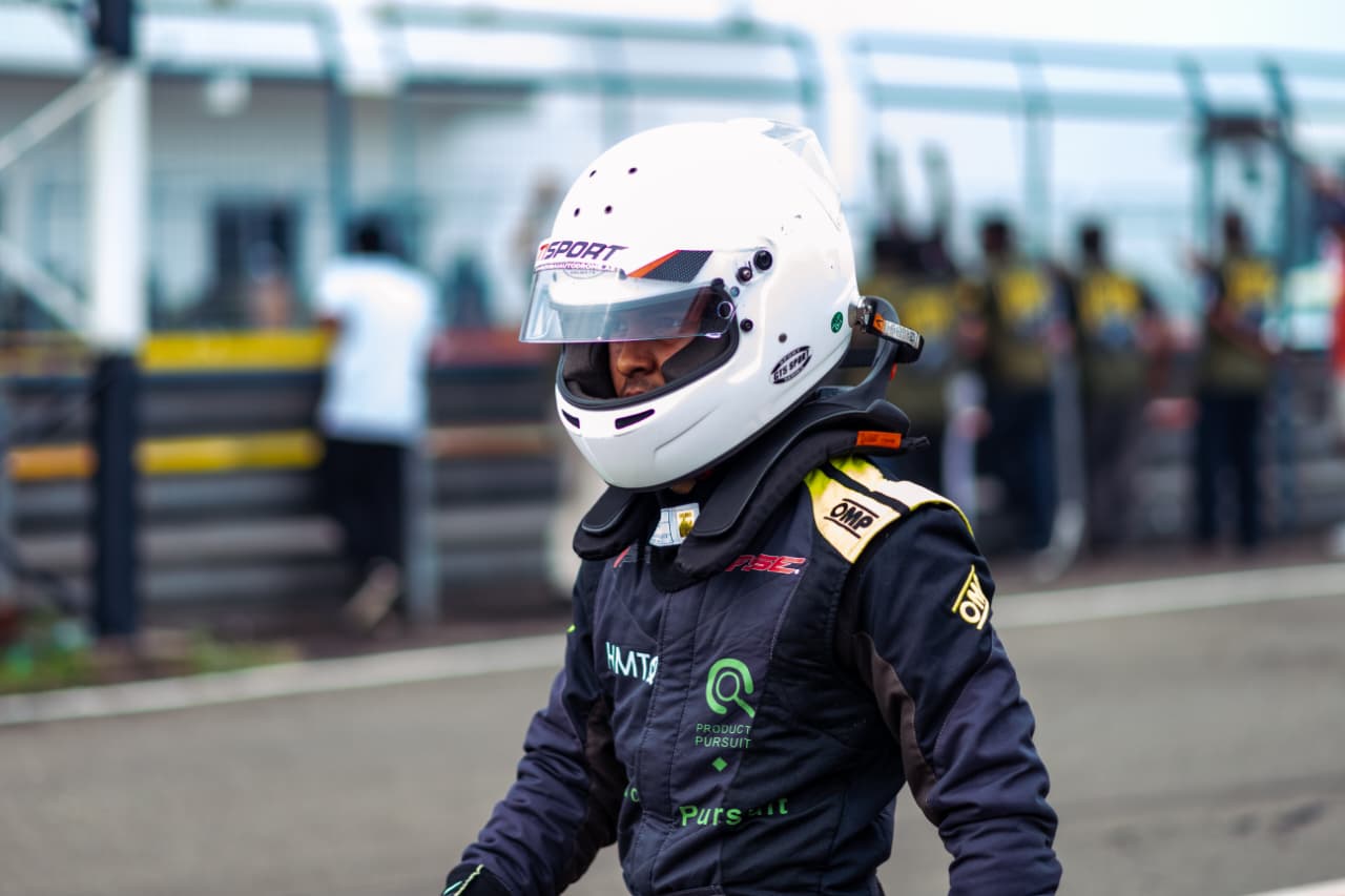 Avi walking through the pit lane with his visor down